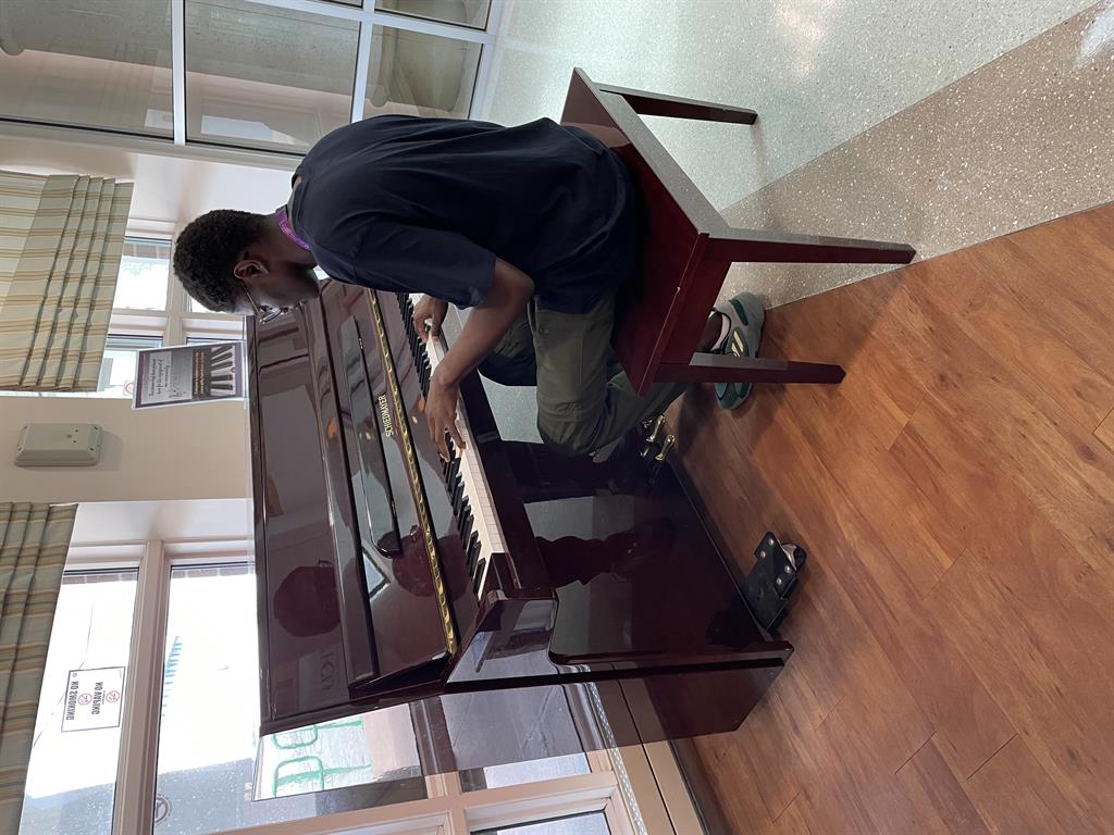 A volunteer playing the piano